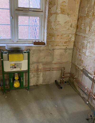 Geberit concealed cistern frame and copper first-fix pipework for a bathroom, Islington
