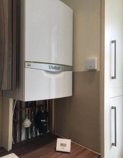Vaillant iQ combi boiler neatly installed in a kitchen cupboard