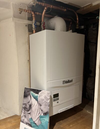 Vaillant system boiler installed in a cellar with overhead copper pipework