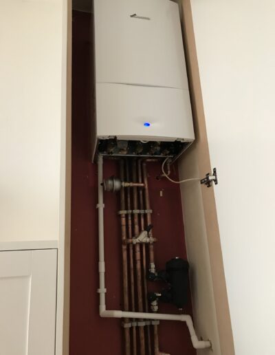 Worcester Bosch boiler installed in a fitted cupboard with MagnaClean filter, Islington